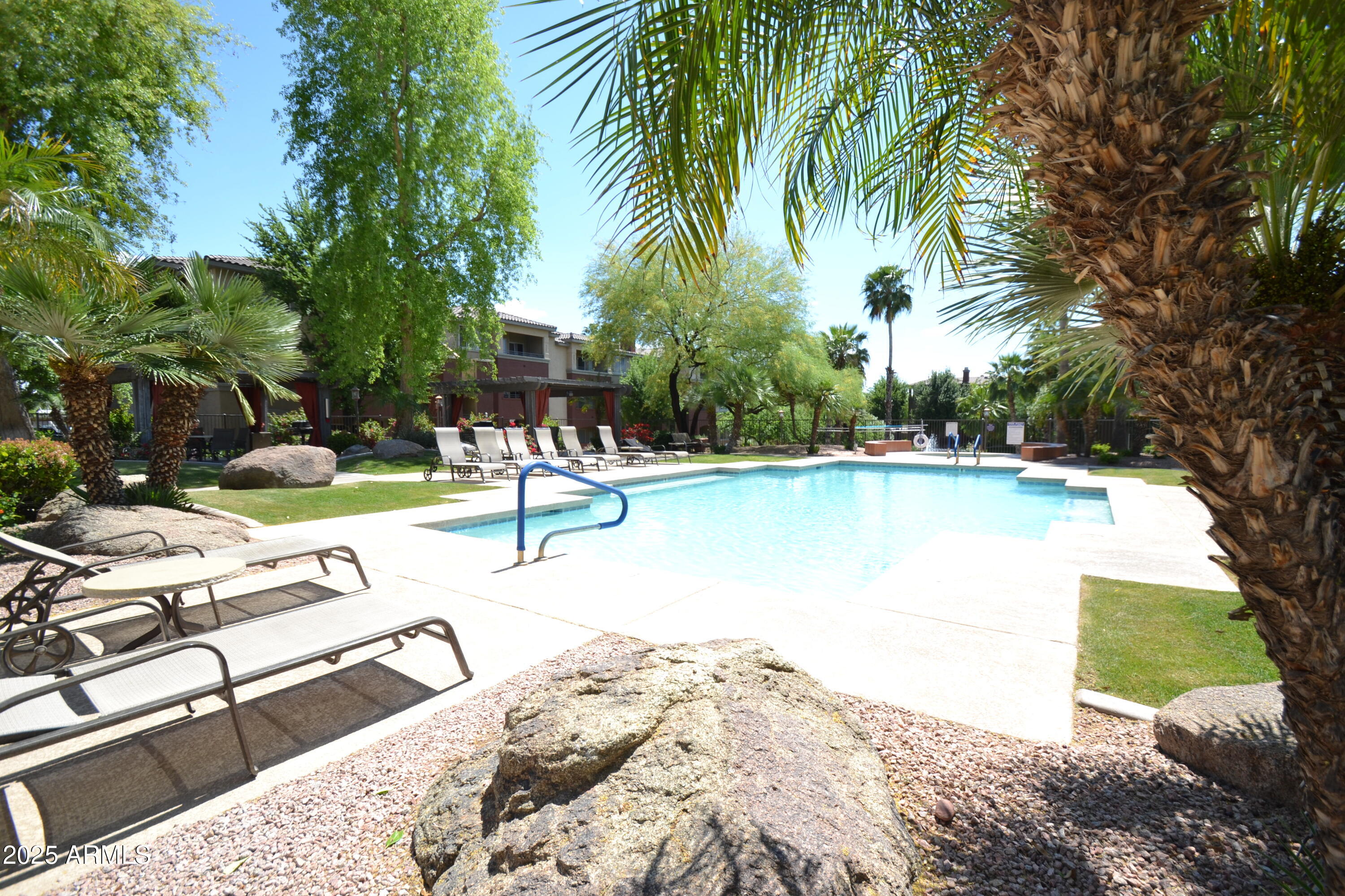5401 East Van Buren Street, Unit 1011 Phoenix, AZ 85008 - Photo 1 of 17 a view of a swimming pool with a patio