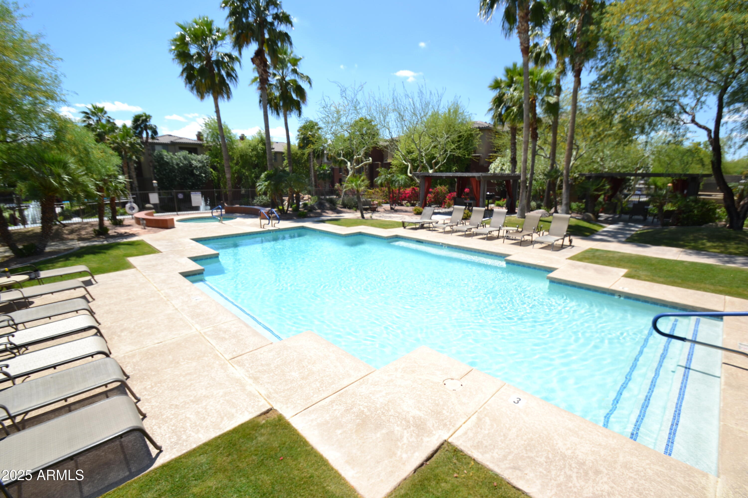 5401 East Van Buren Street, Unit 1011 Phoenix, AZ 85008 - Photo 16 of 17 a view of swimming pool with outdoor seating and plants