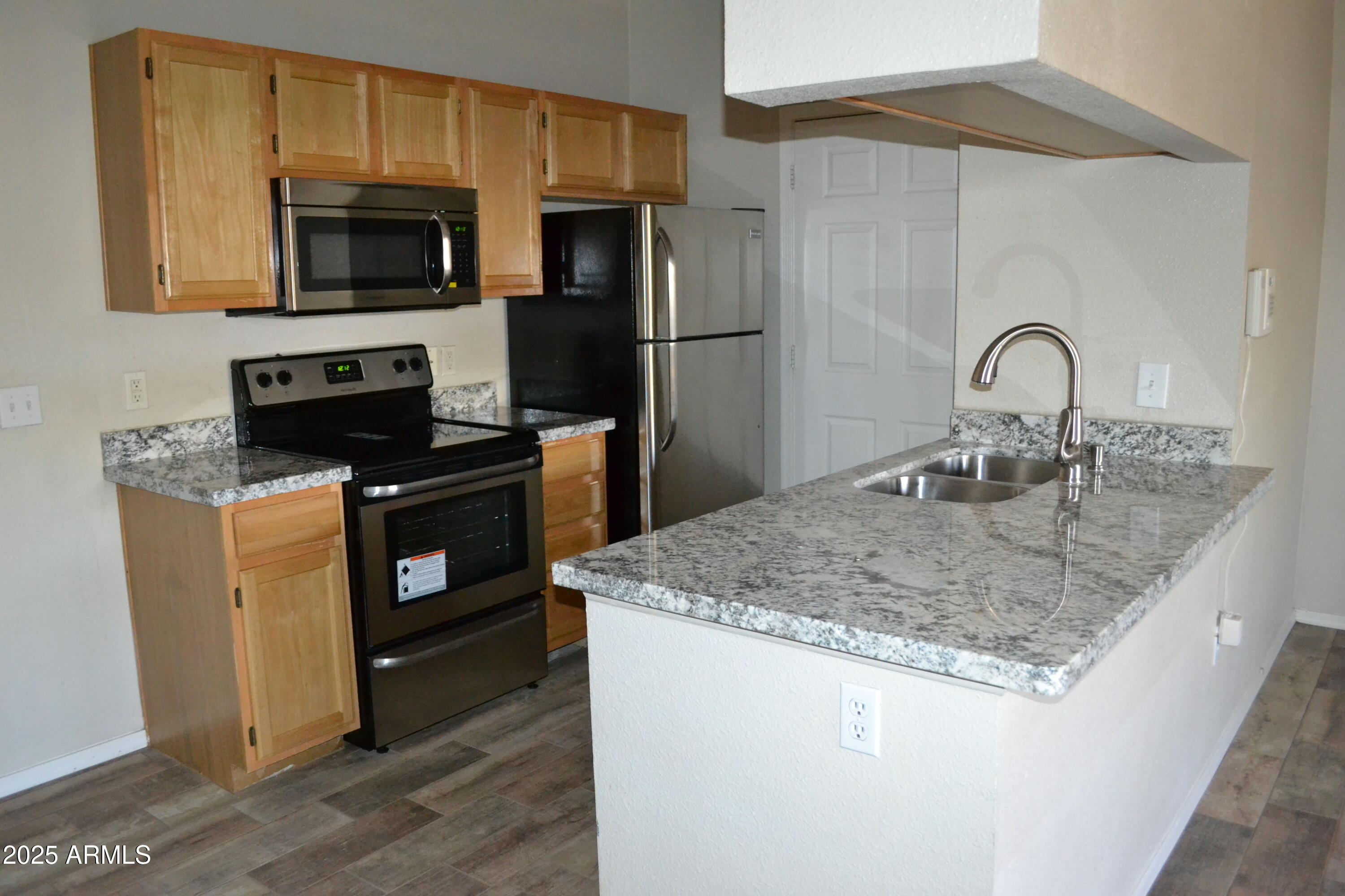 5401 East Van Buren Street, Unit 1011 Phoenix, AZ 85008 - Photo 2 of 17 a kitchen with sink a microwave a stove and refrigerator