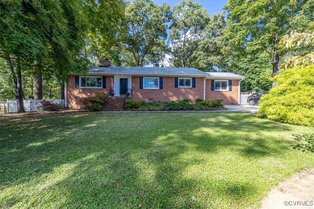7730 Prairie Road Richmond, VA 23225 - Photo 3 of 50 a front view of a house with a garden