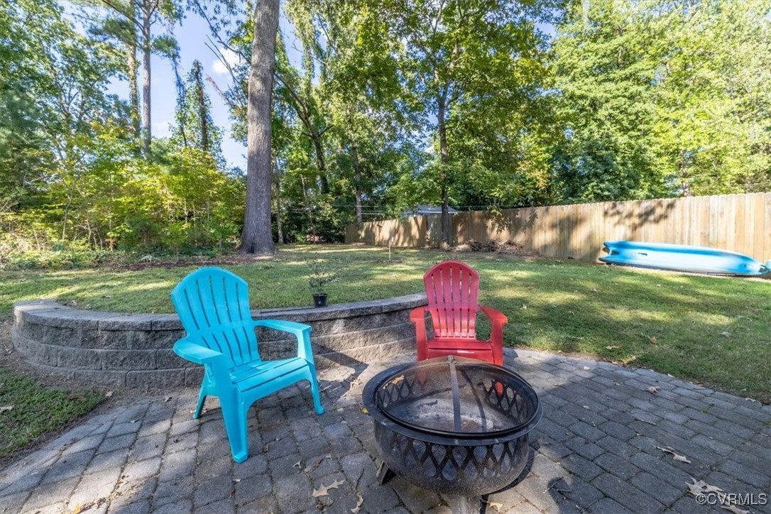 7730 Prairie Road Richmond, VA 23225 - Photo 36 of 50 a view of a table and chairs in backyard of the house