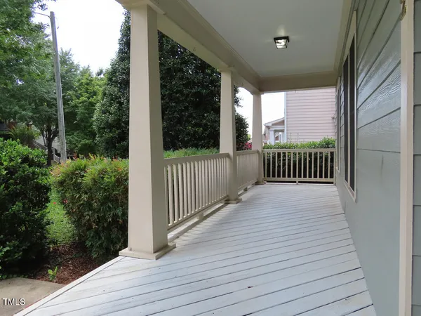 a view of a porch with wooden floor and fence