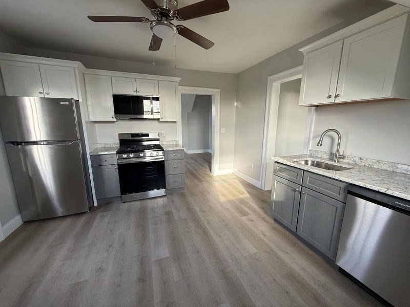 a kitchen with a sink stainless steel appliances and cabinets