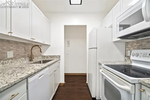 a kitchen with a refrigerator and a sink