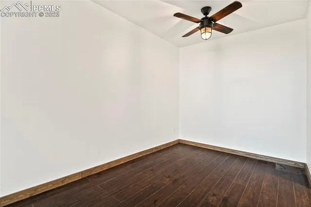 a view of a room with wooden floor and window