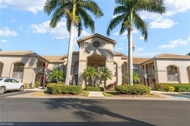 a front view of multiple houses with palm trees