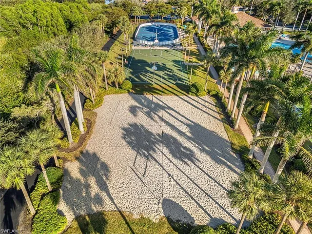 an aerial view of residential houses with outdoor space and lake view
