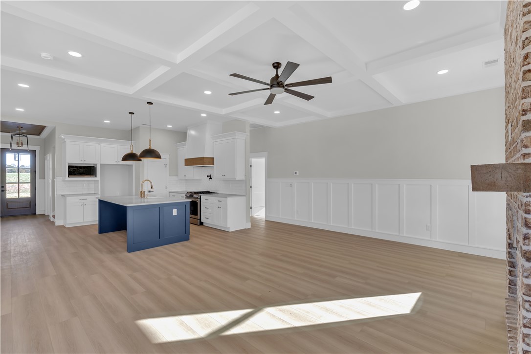 516 Lakeside Drive Anderson, SC 29621 - Photo 21 of 32 An open concept living area boasts a modern kitchen, coffered ceilings, and wide plank flooring.