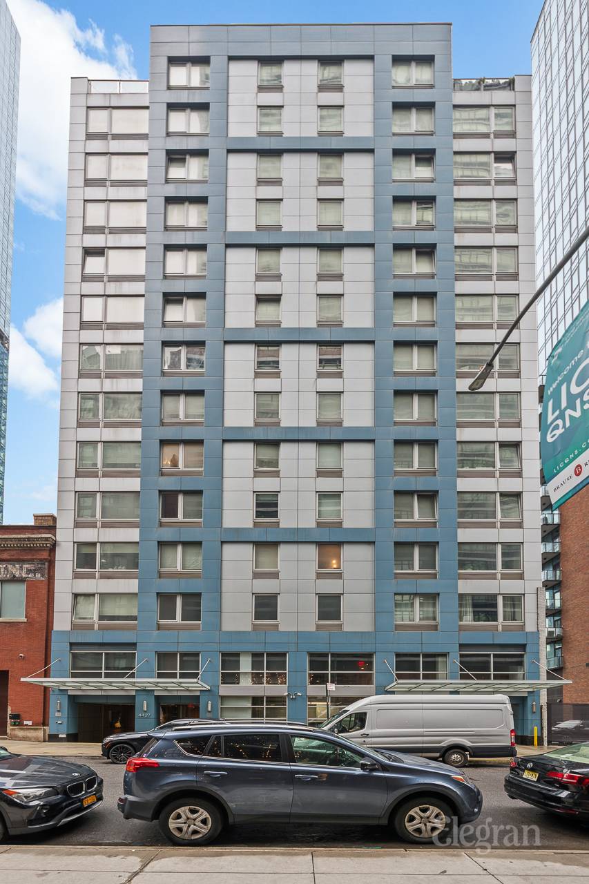 a front view of a building with parking space