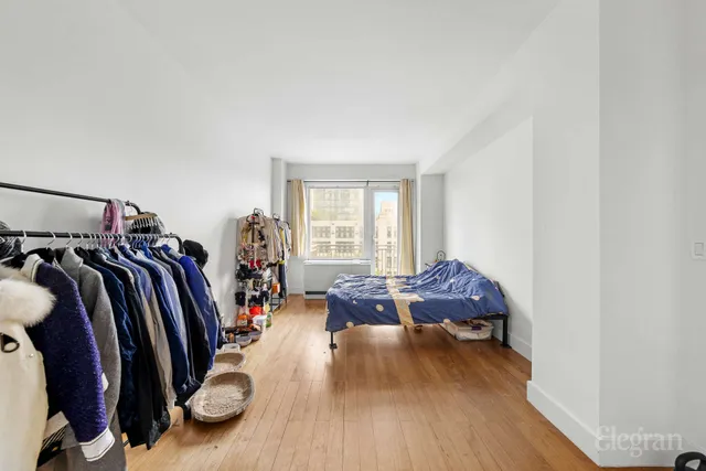 a bed room with a bed and a chair