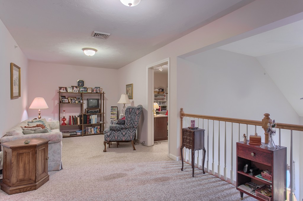 14 Riley Road, Unit 14 Lunenburg, MA 01462 - Photo 23 of 30 a bedroom with furniture and a book shelf