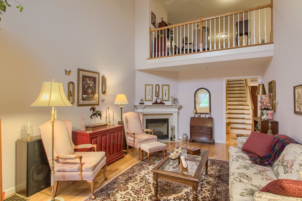 14 Riley Road, Unit 14 Lunenburg, MA 01462 - Photo 3 of 30 a living room with furniture a fireplace and a table