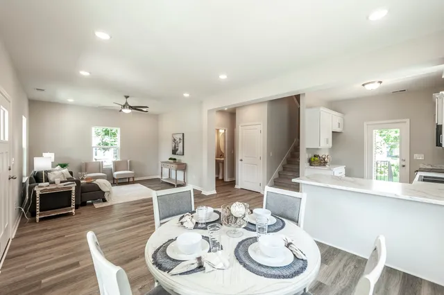 a dining room with furniture a rug and wooden floor