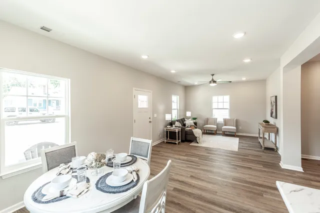 a living room with furniture and wooden floor
