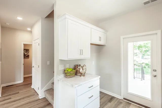 a kitchen with white cabinets stainless steel appliances and sink