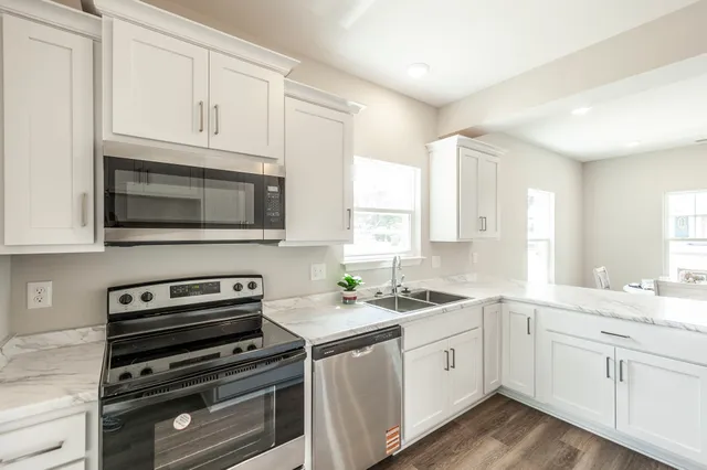a kitchen with a sink stove and cabinets