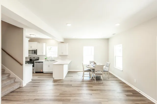 a view of a kitchen with dining table and chairs