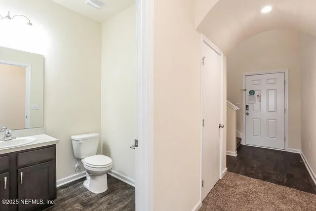 a bathroom with a toilet sink and a mirror