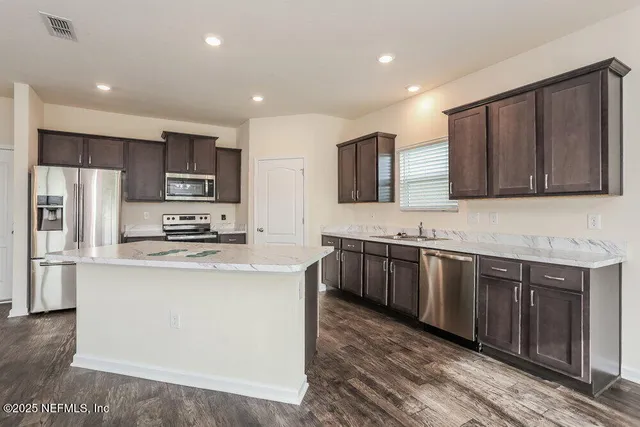 a large kitchen with stainless steel appliances