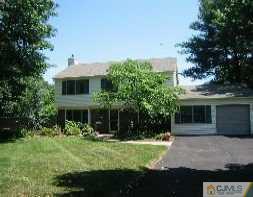 a view of house with a yard