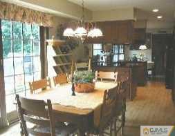 19 MacAfee Road Somerset, NJ 08873 - Photo 3 of 8 a view of a dining room with furniture a chandelier and wooden floor