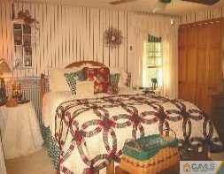 19 MacAfee Road Somerset, NJ 08873 - Photo 5 of 8 a bed sitting in a bedroom next to a window