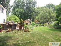 19 MacAfee Road Somerset, NJ 08873 - Photo 7 of 8 a view of backyard with wooden fence and trees