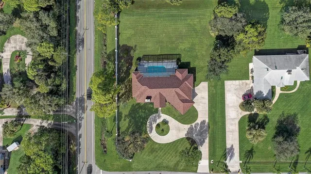 front view of a house with a yard and an trees