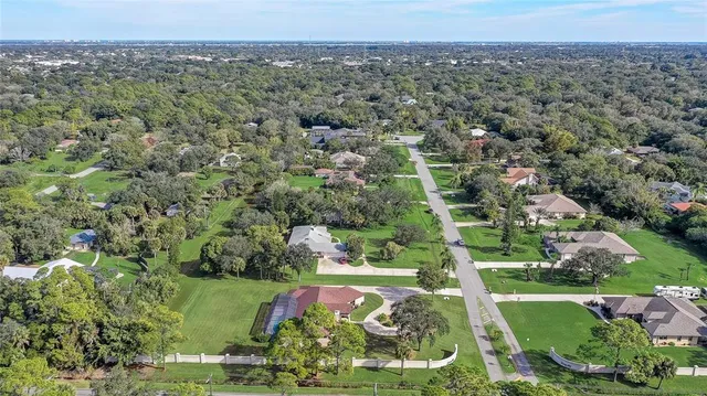 a aerial view of a house with a yard table and chairs