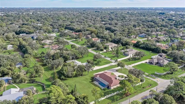 a aerial view of a house with a yard and garage