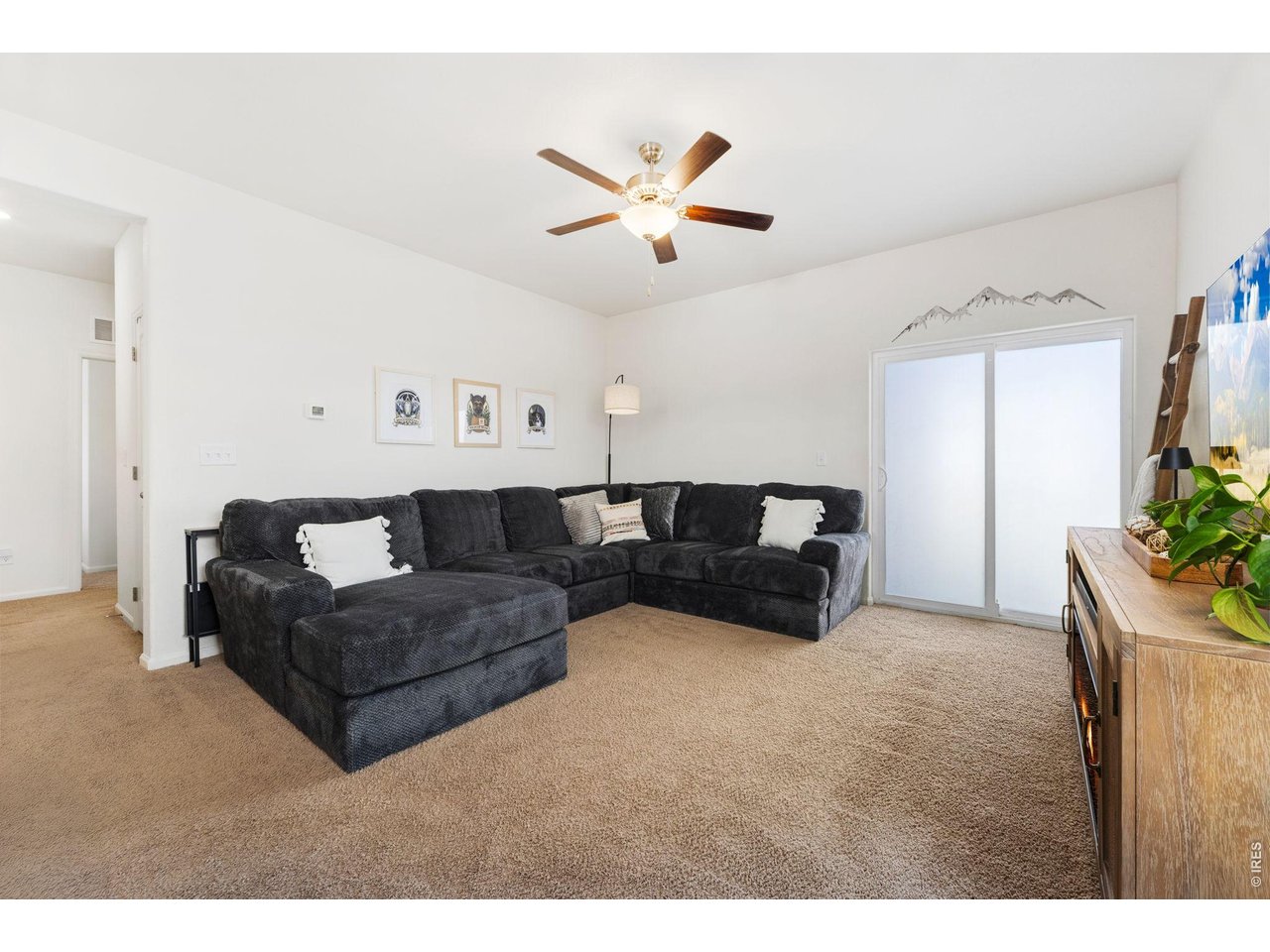 1078 Long Meadows Street Severance, CO 80550 - Photo 6 of 41 Living Room with sliding door to fenced in back yard