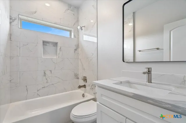 a bathroom with a sink a toilet and a bathtub