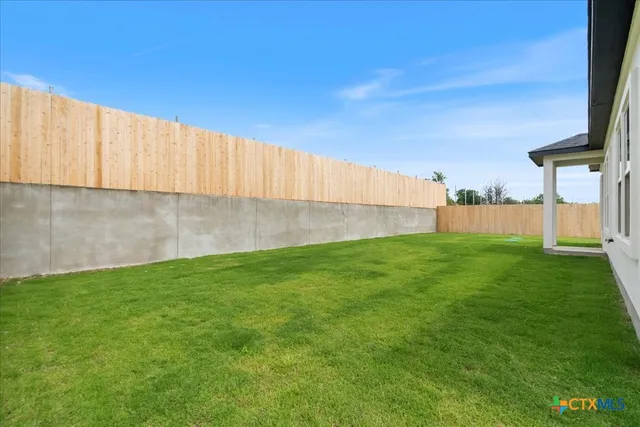 a view of a backyard with a garden and plants