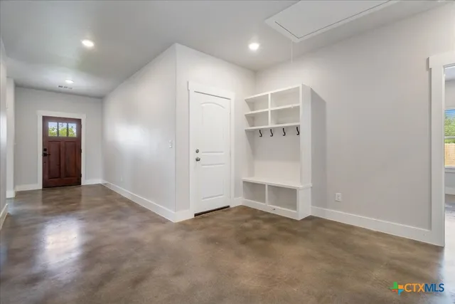 an empty room with windows and cabinet