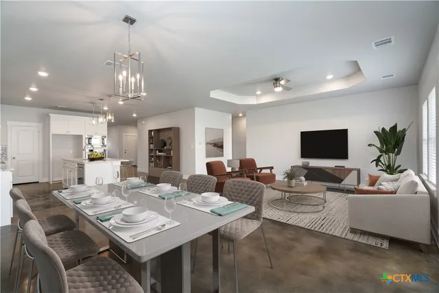 a living room with lots of furniture and a chandelier