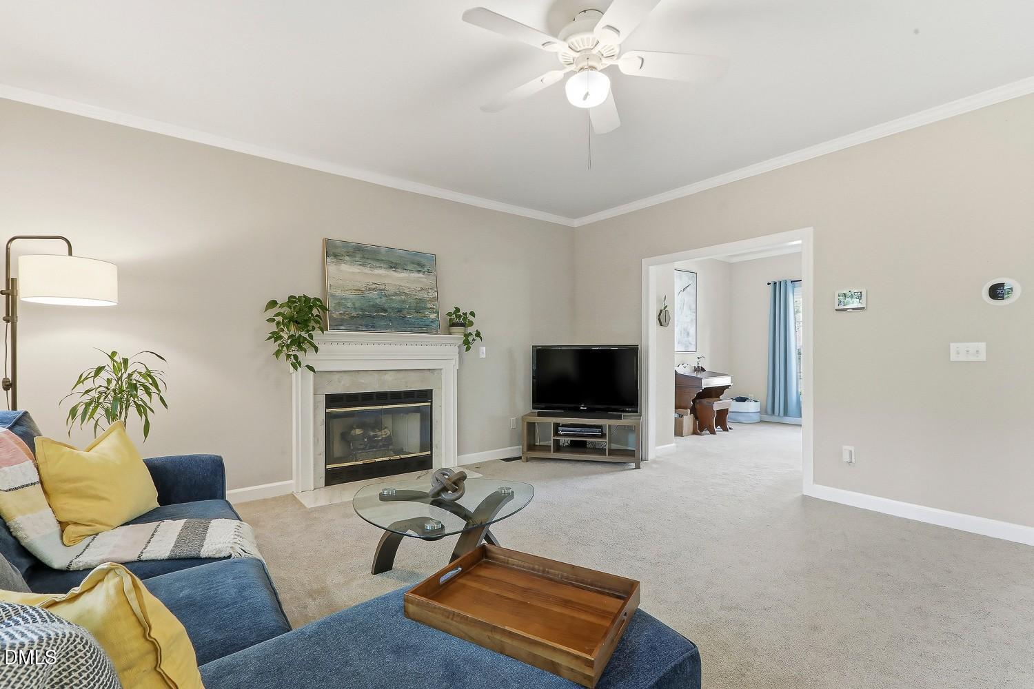4001 Batiste Road Raleigh, NC 27613 - Photo 13 of 63 a living room with furniture a fireplace and a flat screen tv