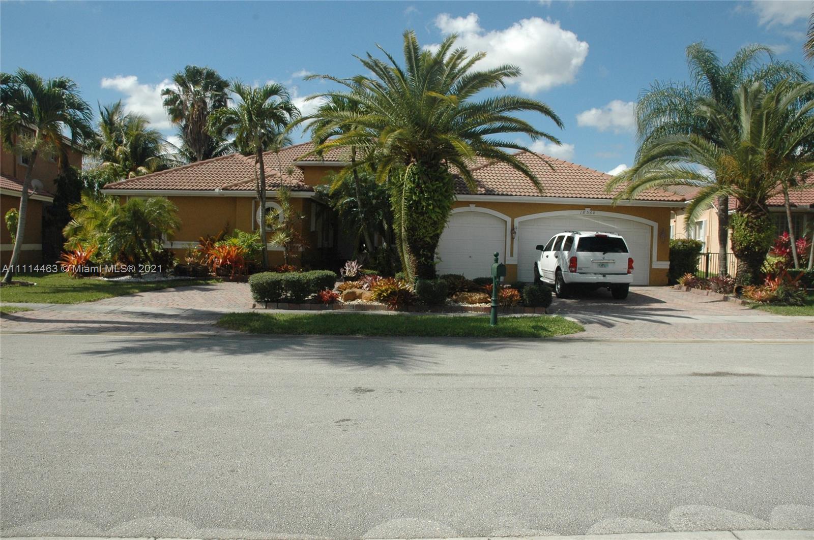 a front view of a house with swimming pool and porch