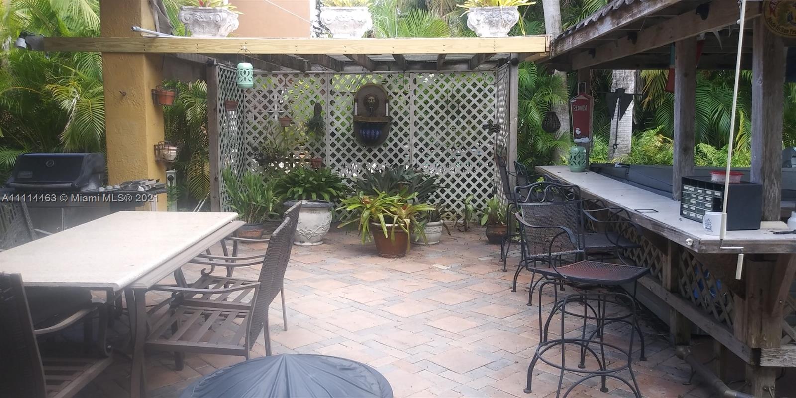 Miramar Miramar, FL 33029 - Photo 9 of 17 a view of a patio with table and chairs potted plants with wooden floor