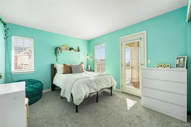 a spacious bedroom with a bed and a window