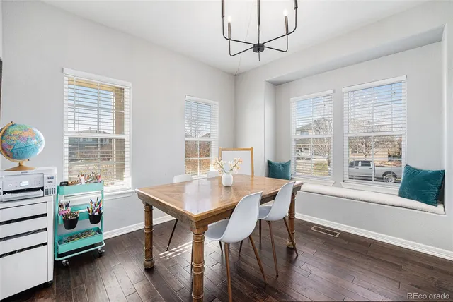a view of a dining room with furniture window and wooden floor