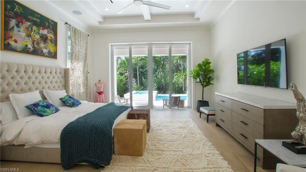 700 Wedge Drive Naples, FL 34103 - Photo 17 of 19 a bedroom with a bed and a flat tv screen