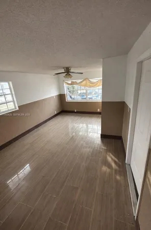 a view of room with window and wooden floor