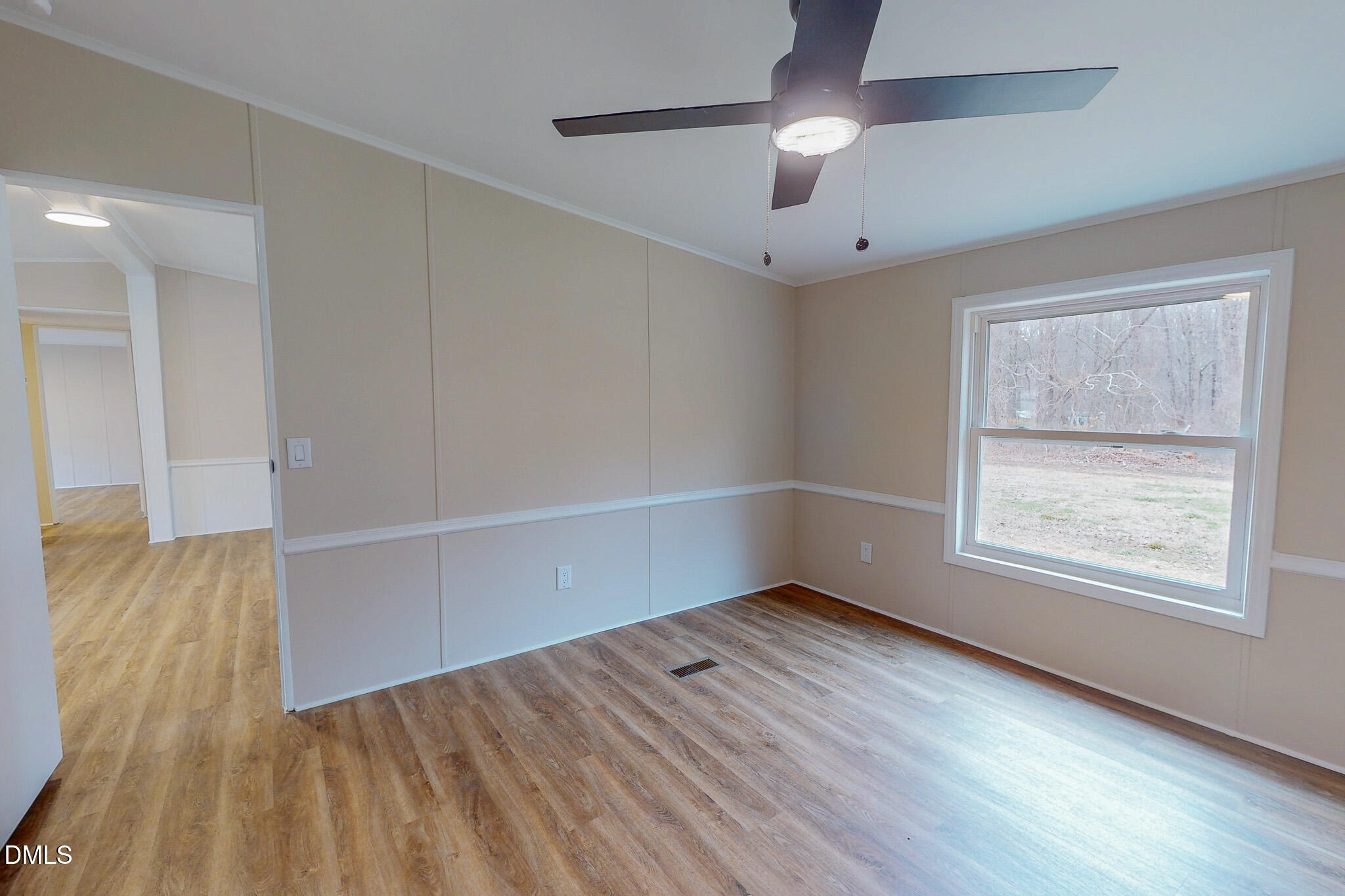 67 Halifax Road Roxboro, NC 27574 - Photo 22 of 48 an empty room with wooden floor chandelier fan and windows