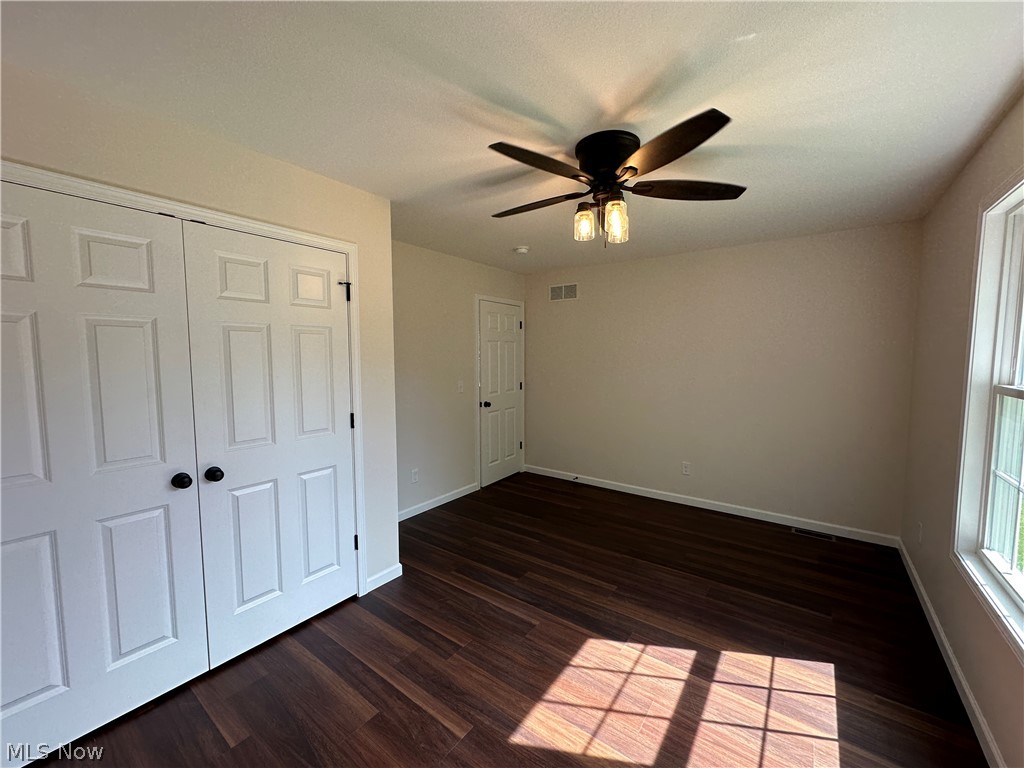 363 Sexton Street Struthers, OH 44471 - Photo 14 of 20 LTV flooring, white paneled doors, and a ceiling fan with integrated lighting