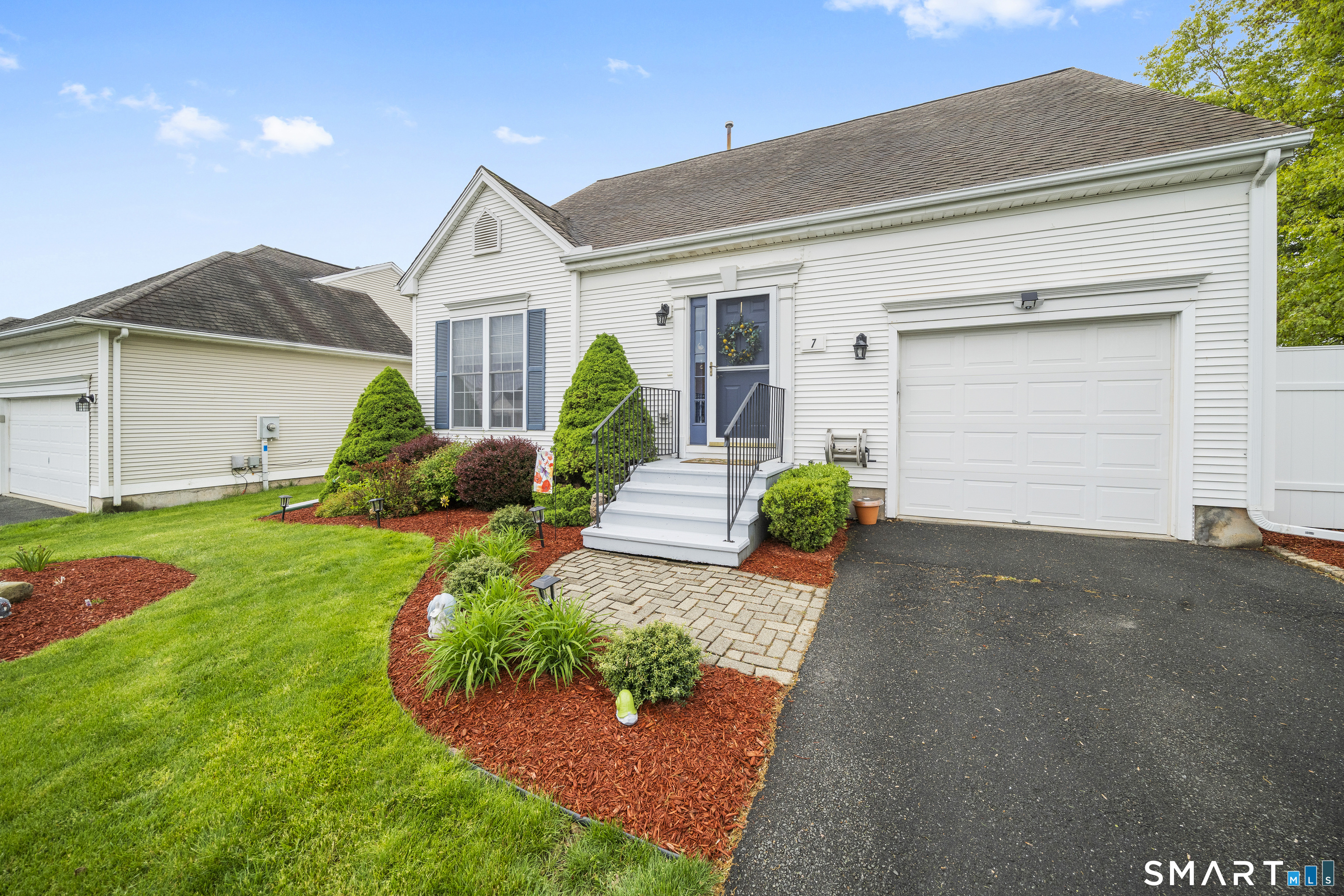 7 Heather Lane, Unit 7 Suffield, CT 06078 - Photo 3 of 34 a front view of a house with garden