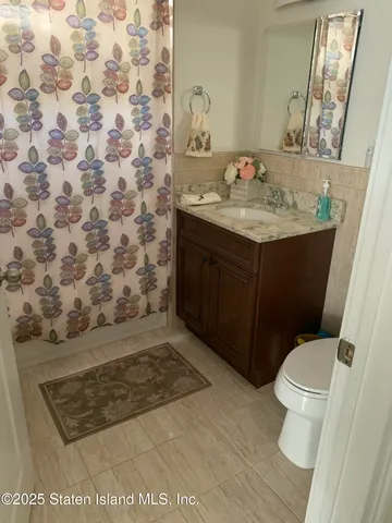 a bathroom with a sink toilet and mirror