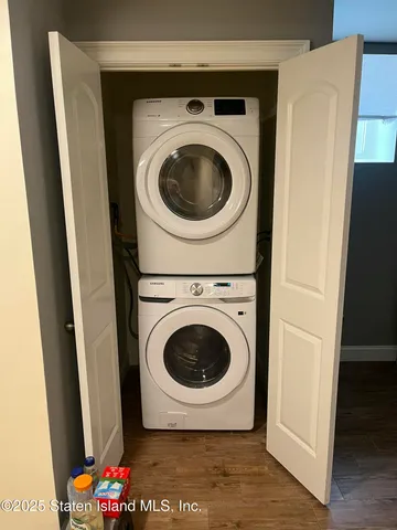 a room with a flat screen tv and a dresser