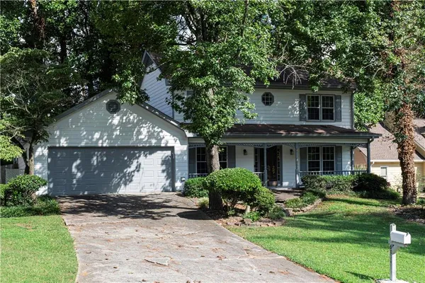 a front view of house with yard and green space