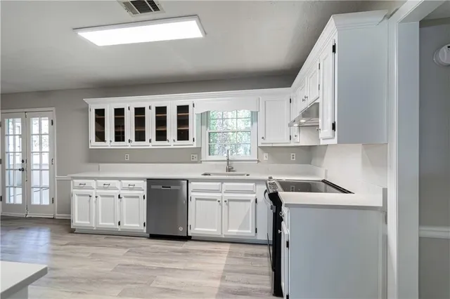 a kitchen with stainless steel appliances granite countertop a stove and cabinets