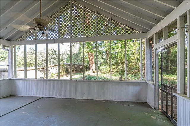 wooden floor in an empty room with a large window